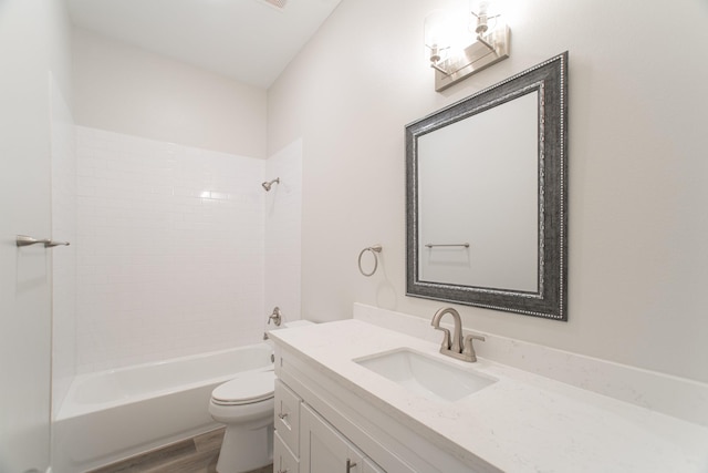 bathroom featuring shower / washtub combination, vanity, toilet, and wood finished floors