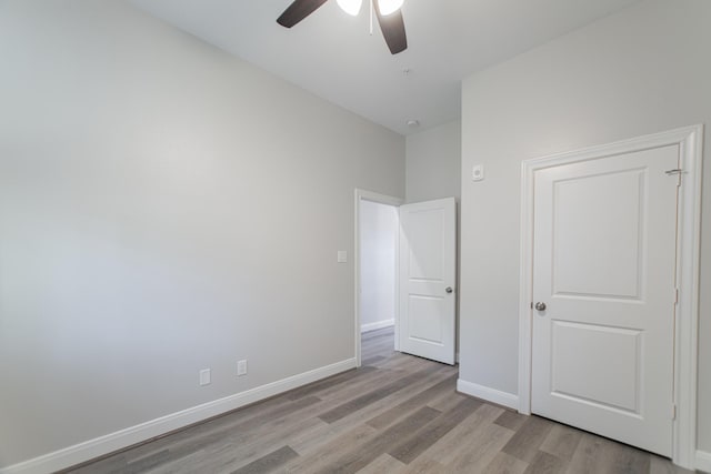 504 Nursery Rd Unit 3202, The Woodlands, TX 77380 - unfurnished bedroom with light wood-style flooring, baseboards, and ceiling fan