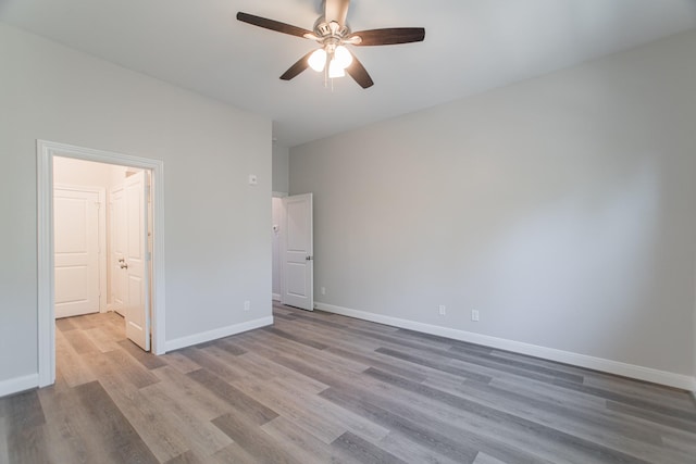 unfurnished bedroom with a ceiling fan, baseboards, and wood finished floors