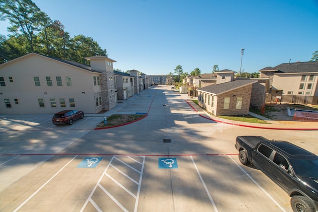 view of road featuring a residential view and curbs