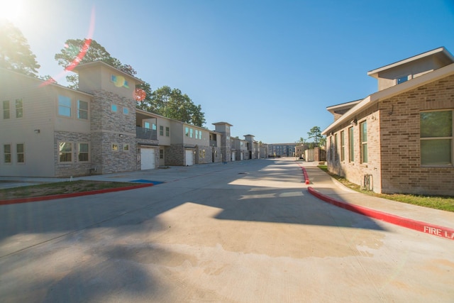 view of street with a residential view, curbs, and sidewalks