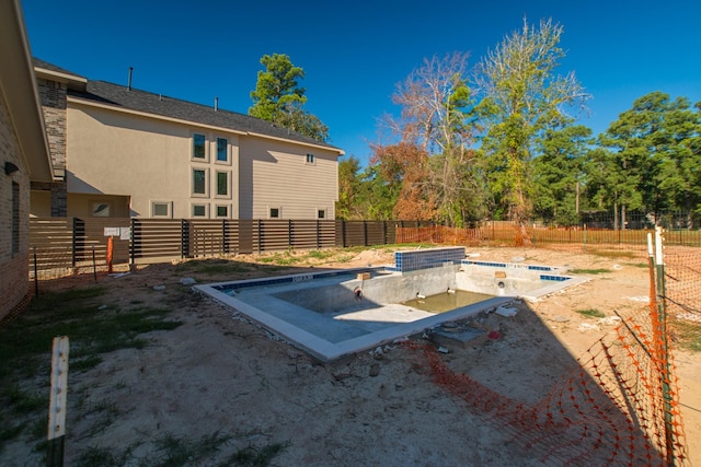 entry to storm shelter with a fenced backyard