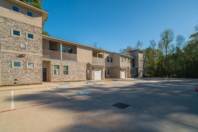 view of property with uncovered parking