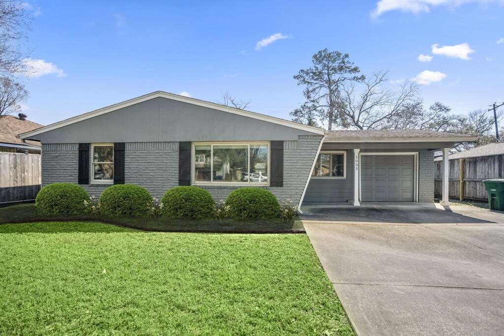 5033 W 43rd St, Houston, TX 77092 - single story home with fence, concrete driveway, a front yard, an attached garage, and brick siding