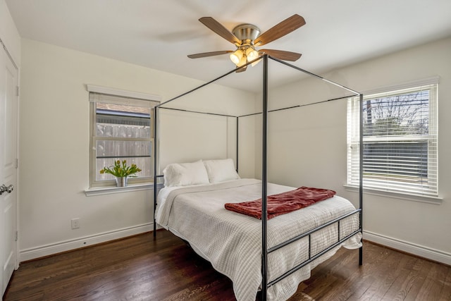 bedroom with a ceiling fan, baseboards, and wood finished floors