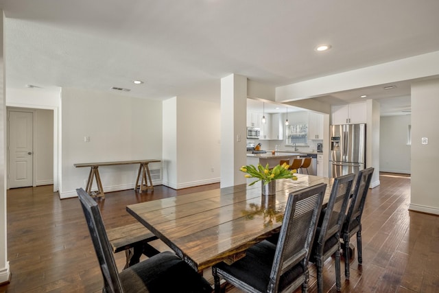 dining room with dark wood finished floors, visible vents, and recessed lighting