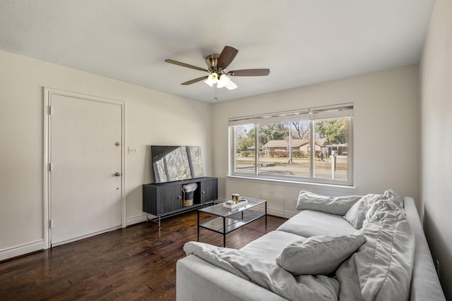 living room with baseboards, wood finished floors, and a ceiling fan