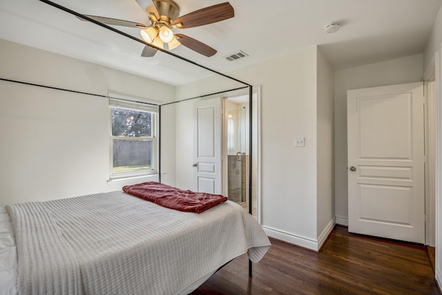 bedroom featuring ceiling fan, visible vents, baseboards, and wood finished floors