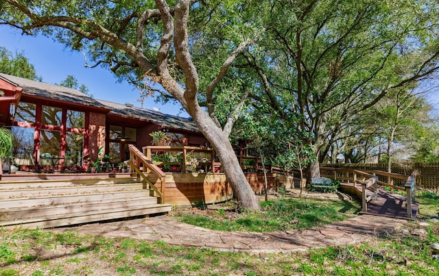 view of yard featuring a wooden deck and fence