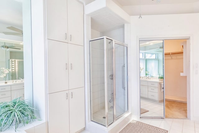 full bathroom with vanity, tile patterned floors, a ceiling fan, and a stall shower