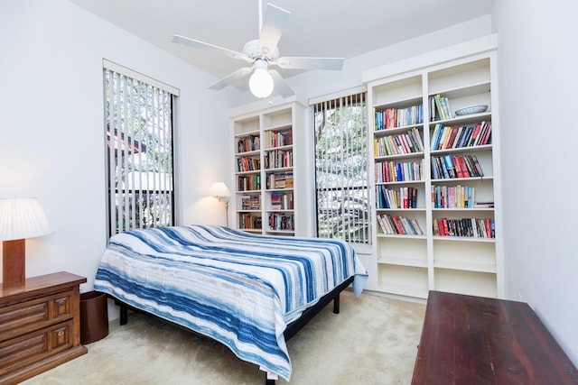 carpeted bedroom featuring multiple windows