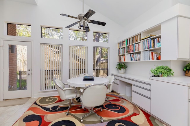 office with light tile patterned flooring, high vaulted ceiling, ceiling fan, and built in desk