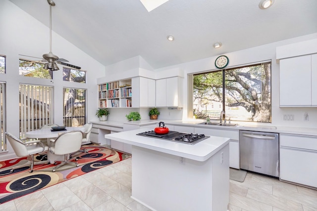 kitchen featuring ceiling fan, light countertops, appliances with stainless steel finishes, white cabinets, and a sink