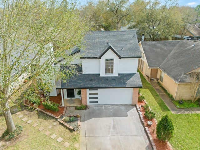 view of front of house with brick siding, a shingled roof, a front yard, a garage, and driveway