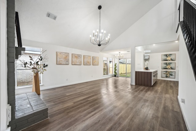 unfurnished living room with dark wood-style flooring, visible vents, baseboards, and an inviting chandelier