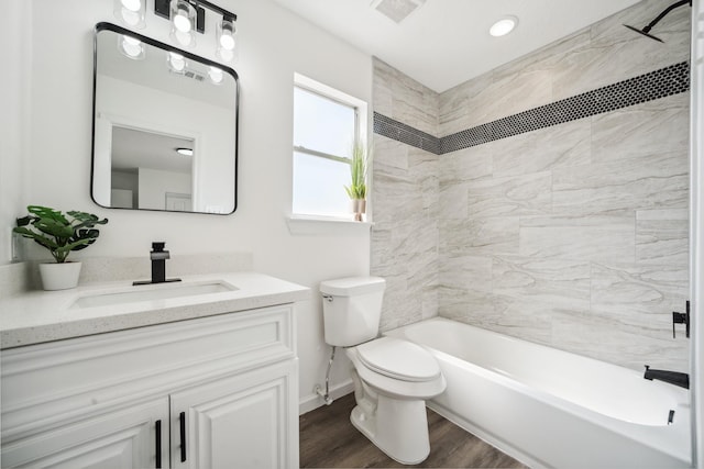 full bath with visible vents, toilet, tub / shower combination, vanity, and wood finished floors