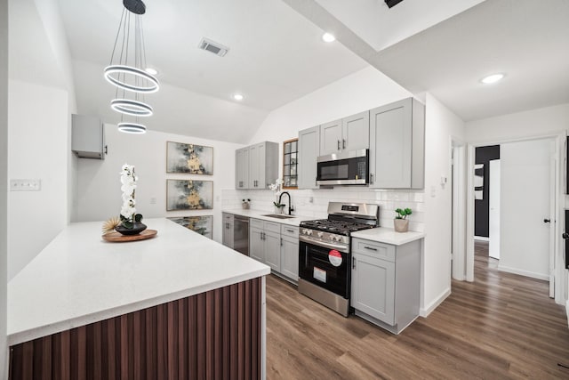 kitchen featuring stainless steel appliances, gray cabinets, a sink, and visible vents