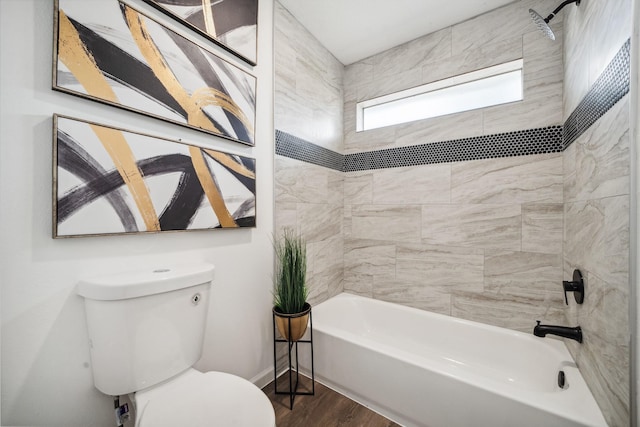 full bath featuring bathtub / shower combination, baseboards, toilet, and wood finished floors