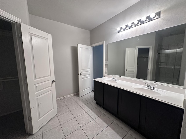 8218 Malago Point Dr, Cypress, TX 77433 - bathroom featuring double vanity, a sink, tile patterned floors, and a closet