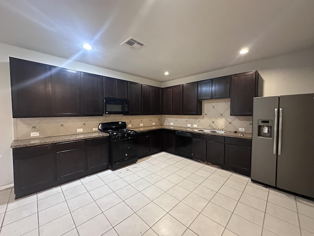 kitchen with tasteful backsplash, visible vents, light tile patterned flooring, a sink, and black appliances