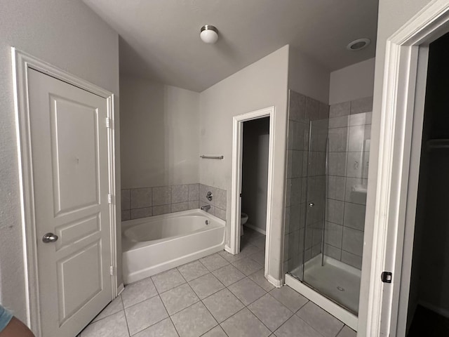 bathroom with toilet, a garden tub, a shower stall, and tile patterned floors