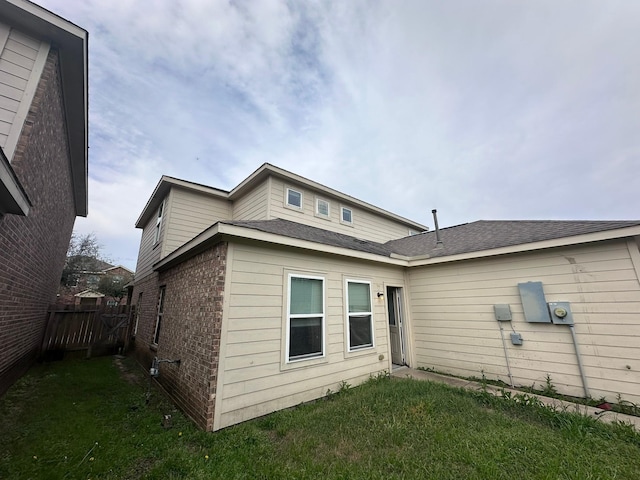 8218 Malago Point Dr, Cypress, TX 77433 - rear view of property featuring fence, a lawn, and brick siding