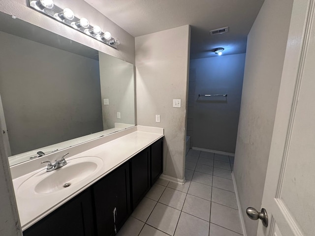 bathroom featuring visible vents, tile patterned flooring, vanity, and baseboards