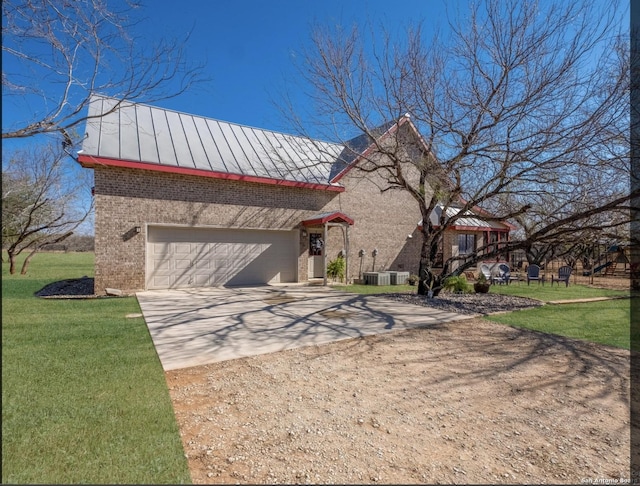 view of front of property featuring driveway, metal roof, a standing seam roof, a front lawn, and brick siding