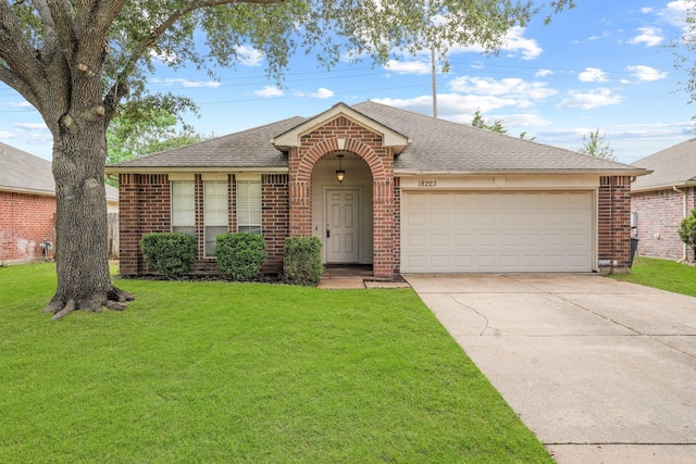 ranch-style home with brick siding, a shingled roof, concrete driveway, an attached garage, and a front yard