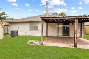 back of house with a yard, cooling unit, and fence