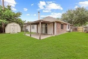 back of house featuring a yard, a storage shed, a patio area, fence, and an outdoor structure