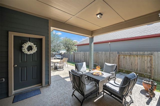 view of patio / terrace featuring outdoor dining area, fence, and a fire pit