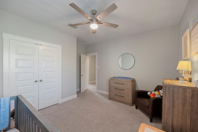 bedroom with light carpet, visible vents, baseboards, ceiling fan, and a closet