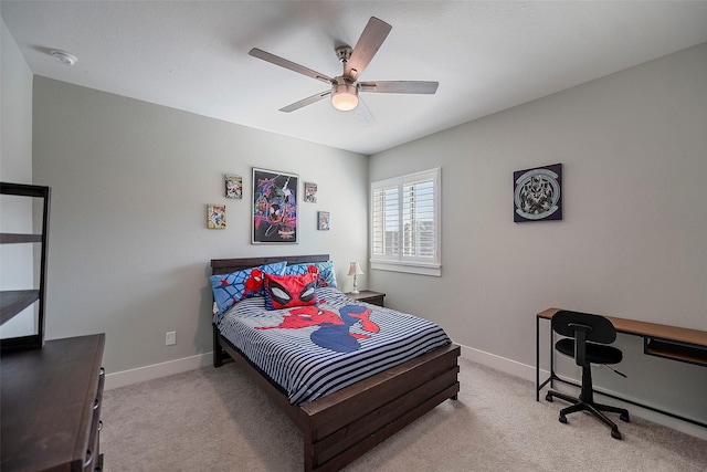 carpeted bedroom featuring baseboards and a ceiling fan