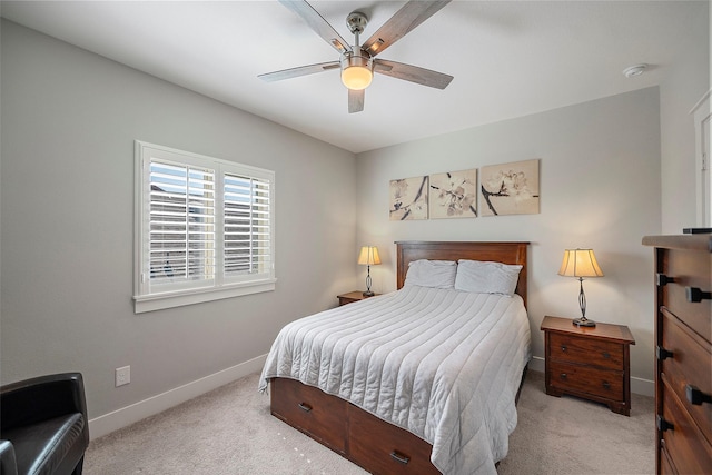 carpeted bedroom featuring ceiling fan and baseboards