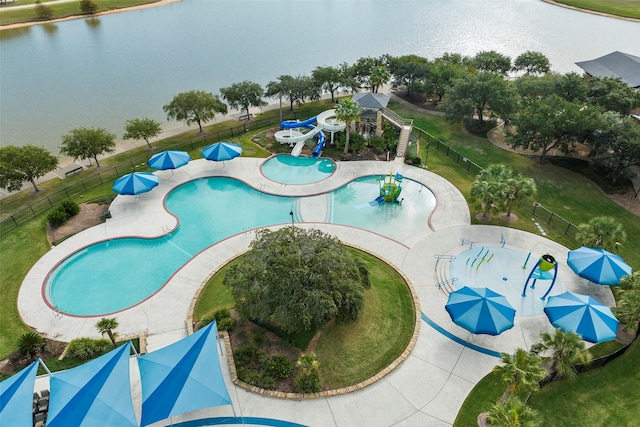 pool with a water slide, a water play area, a water view, and a fenced backyard