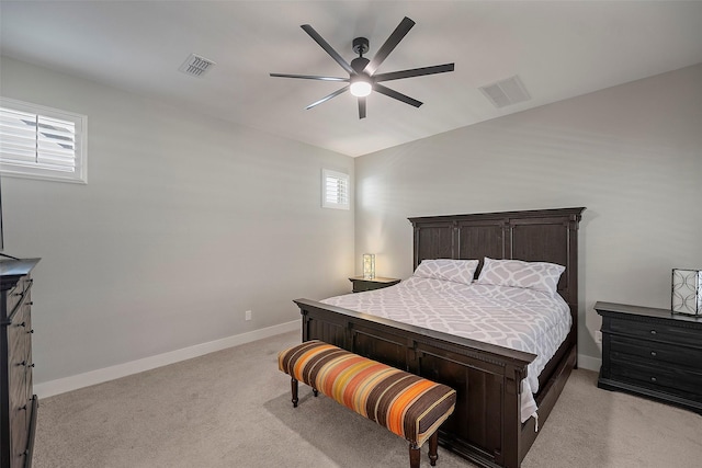 bedroom featuring a ceiling fan, visible vents, light carpet, and baseboards