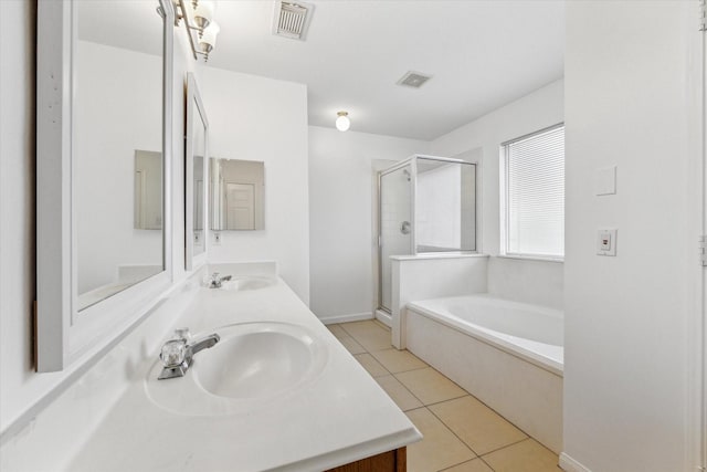 full bath featuring a bath, tile patterned flooring, visible vents, and a sink