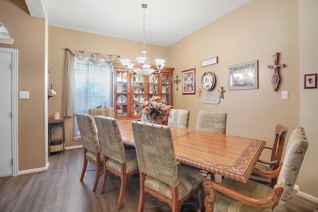 dining area with a notable chandelier, baseboards, and wood finished floors