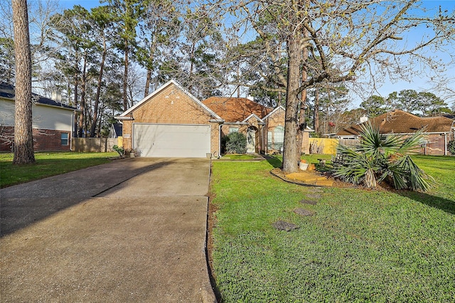 view of front of property with brick siding, concrete driveway, fence, a garage, and a front lawn