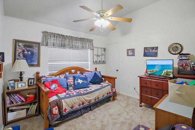 bedroom with a ceiling fan, vaulted ceiling, and carpet flooring