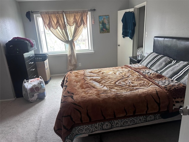 carpeted bedroom featuring baseboards