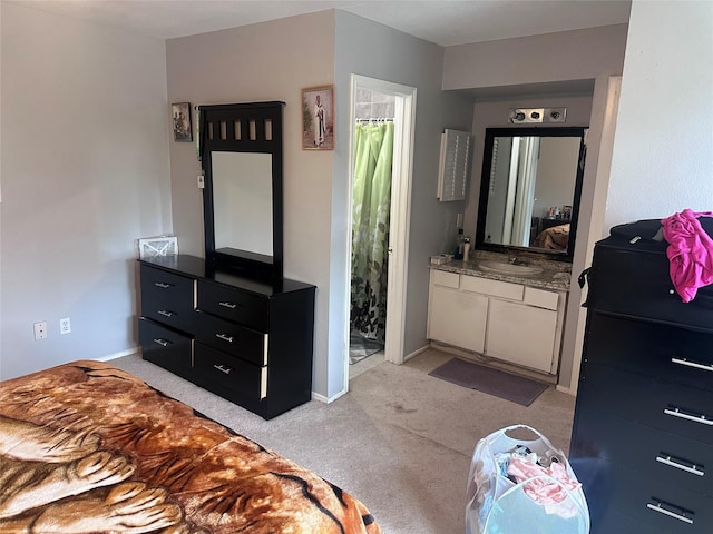 bedroom featuring light carpet, a sink, and baseboards