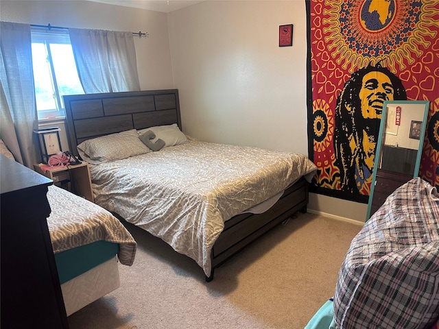 bedroom with carpet floors and baseboards