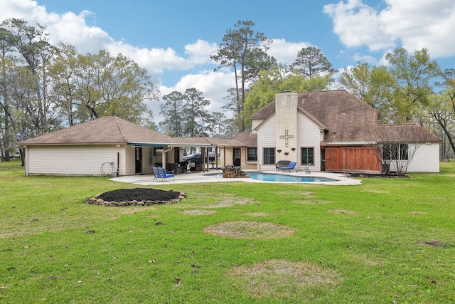 5503 Bayou Blvd, Baytown, TX 77521 - back of house with a patio area, an outdoor pool, a chimney, and a yard
