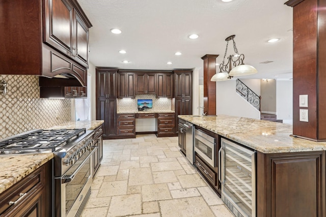 5503 Bayou Blvd, Baytown, TX 77521 - kitchen with light stone counters, recessed lighting, stone tile flooring, wine cooler, and high end stainless steel range