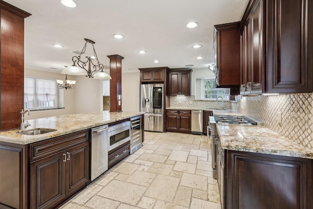 5503 Bayou Blvd, Baytown, TX 77521 - kitchen featuring beverage cooler, stone tile floors, stainless steel appliances, and a sink