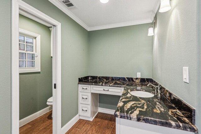 5503 Bayou Blvd, Baytown, TX 77521 - bathroom with visible vents, toilet, wood finished floors, crown molding, and baseboards