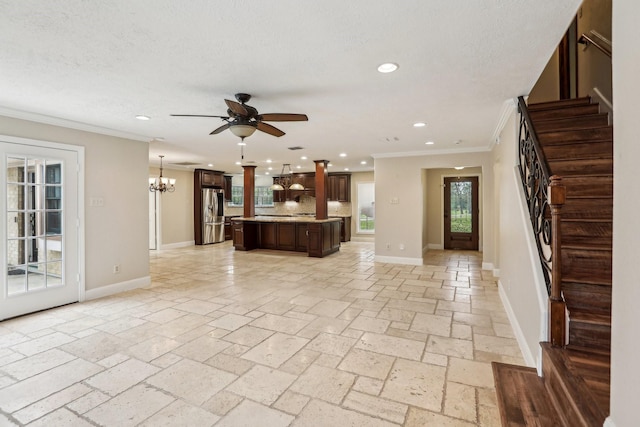 5503 Bayou Blvd, Baytown, TX 77521 - unfurnished living room featuring stairway, baseboards, ornamental molding, stone tile flooring, and ceiling fan with notable chandelier