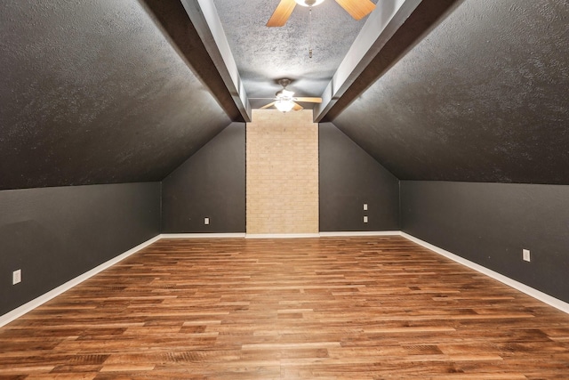 5503 Bayou Blvd, Baytown, TX 77521 - bonus room with baseboards, a textured ceiling, a ceiling fan, and wood finished floors